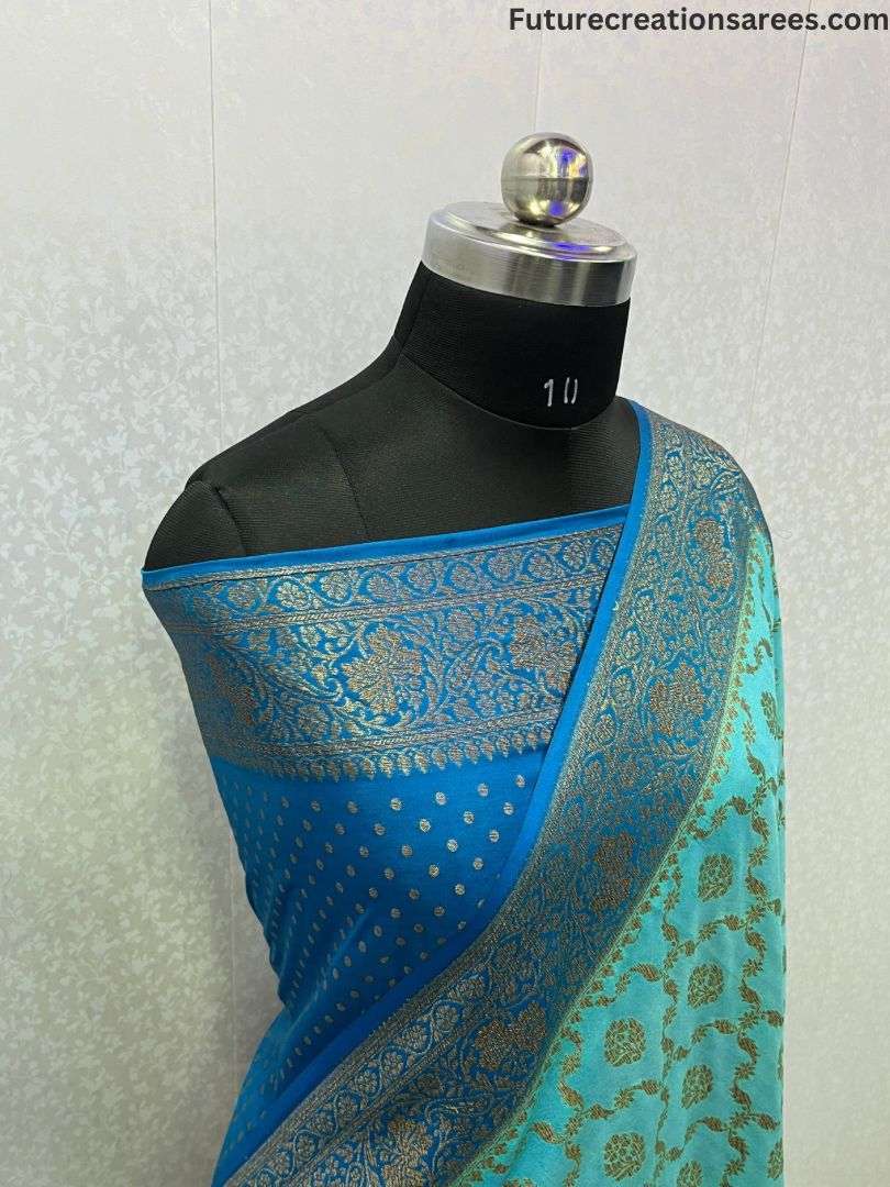 Blue saree with intricate GOLDEN ZARI embroidery, draped on black mannequin
